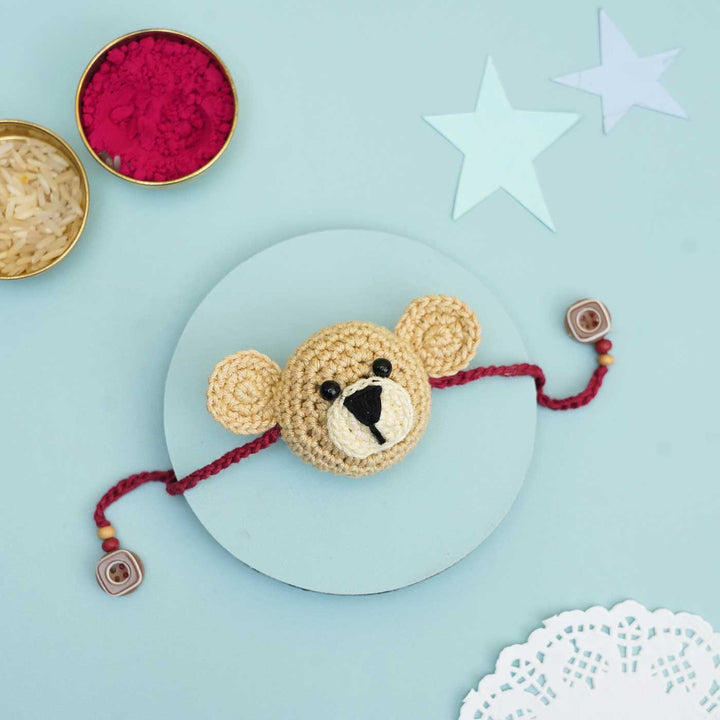 Handmade Crochet Teddy Hug Kids Rakhi With Roli Chawal - Flat Lay on Circular Board