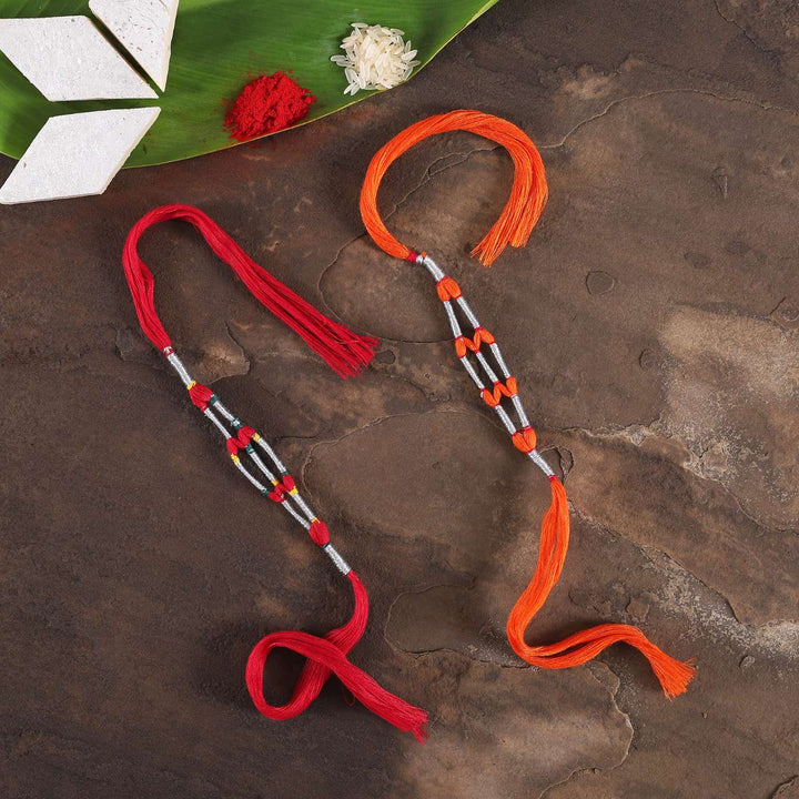 Handmade Beaded Jaali Zari Rakhi With Roli Chawal Set Of 2 - Top View with Festive Items