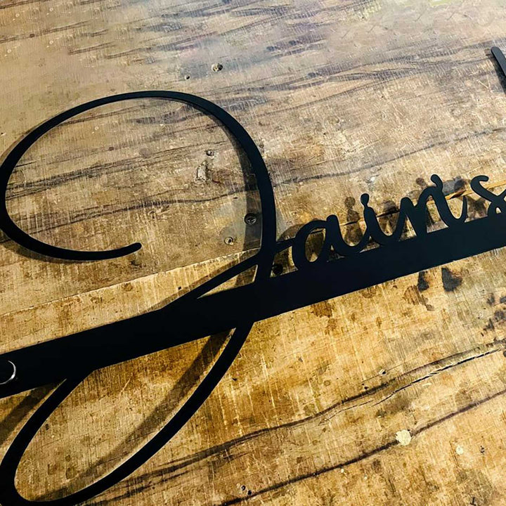 Personalized Waterproof Jains Elegant Design Metal Name Plate - Angled Close-up on Wooden Surface