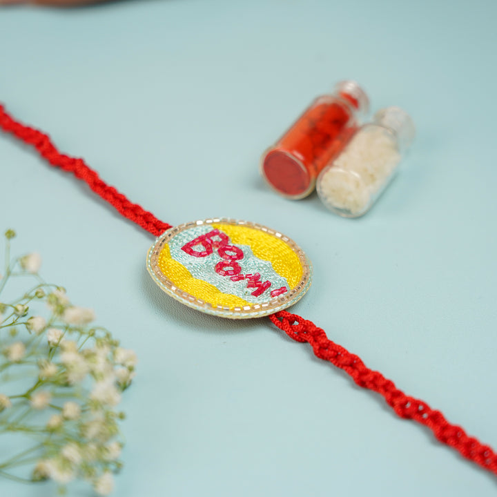 Handmade Beaded Boom Superhero Rakhi With Roli Chawal For Brother - Rakhi Laid Flat with Roli Chawal