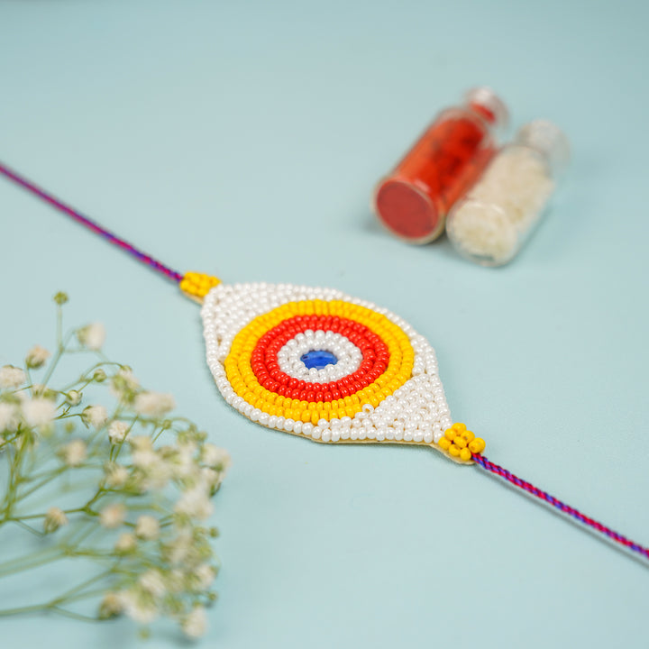 Handmade Beaded Colourful Evil Eye Rakhi With Roli Chawal - Front View of Beaded Rakhi