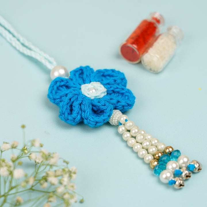 Customized Handmade Crochet Rubi Petal Floral Bhaiya Bhabhi Rakhi With Roli Chawal - Close-up of crocheted flower pair