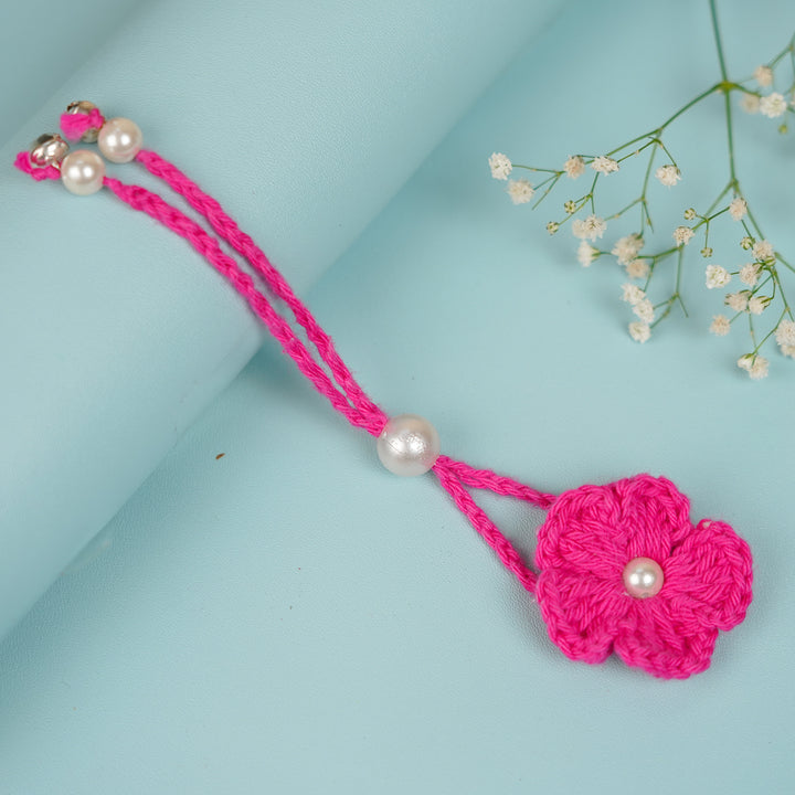 Handmade Crochet Scarlet Knot Lumba Rakhi For Bhabhi With Roli Chawal - Full View with Overlapping Background