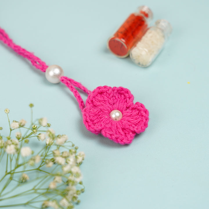 Handmade Crochet Scarlet Knot Lumba Rakhi For Bhabhi With Roli Chawal - Close-up of Crochet Flower Detail
