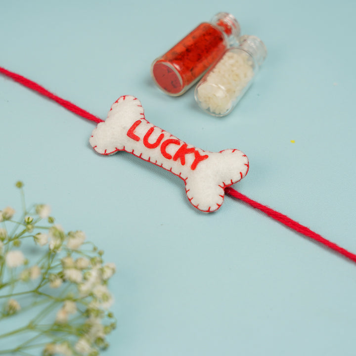Personalized Handmade Bone Theme Felt Rakhi With Roli Chawal - Lucky bone with Roli Chawal bottles