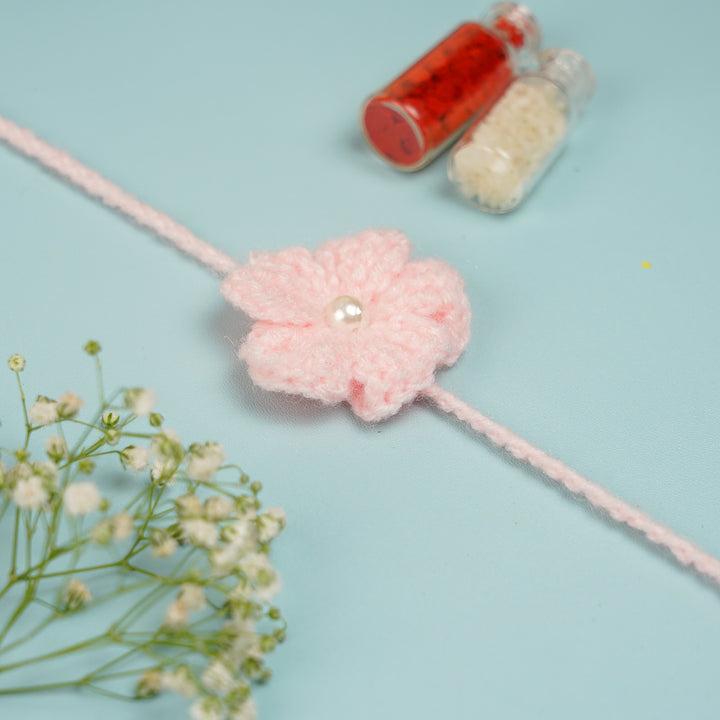 Customized Handmade Crochet Floral Rakhi With Roli Chawal For Brother - Side View of Pink Rakhi with Accessories