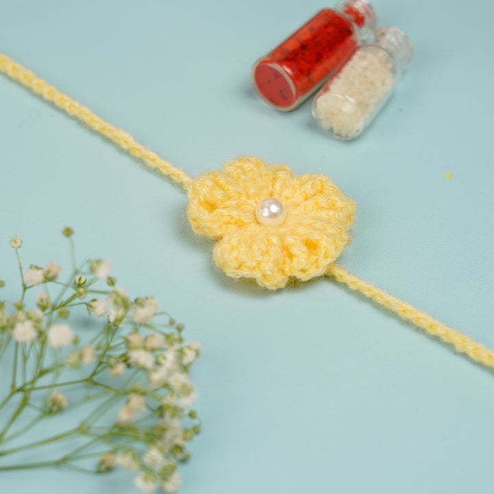 Customized Handmade Crochet Floral Rakhi With Roli Chawal For Brother - Close-up of Yellow Rakhi Flower