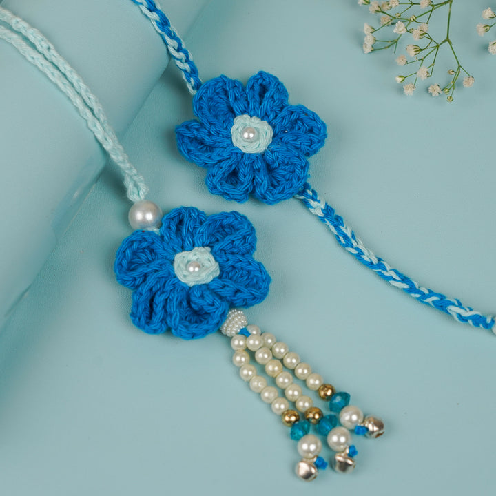 Customized Handmade Crochet Rubi Petal Floral Bhaiya Bhabhi Rakhi With Roli Chawal - Close-up of blue crochet flower detail