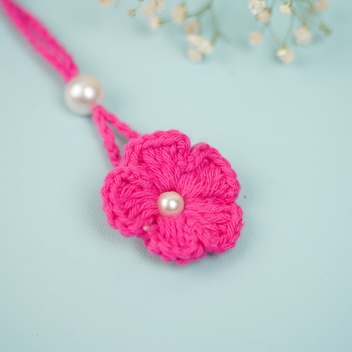 Handmade Crochet Scarlet Knot Lumba Rakhi For Bhabhi With Roli Chawal - Close-up of Flower and Pearl