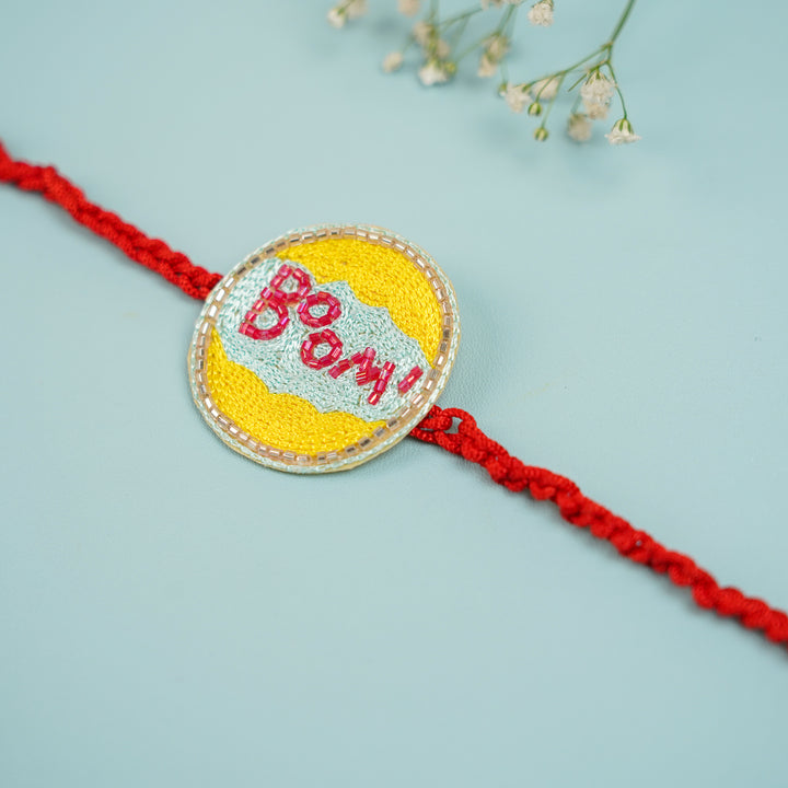 Handmade Beaded Boom Superhero Rakhi With Roli Chawal For Brother - Detailed Side Angle of Rakhi Centerpiece