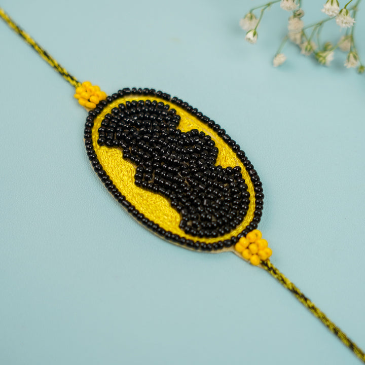 Handmade Beaded Batman Theme Rakhi With Roli Chawal For Brother - Angled Close-up of Rakhi Beads
