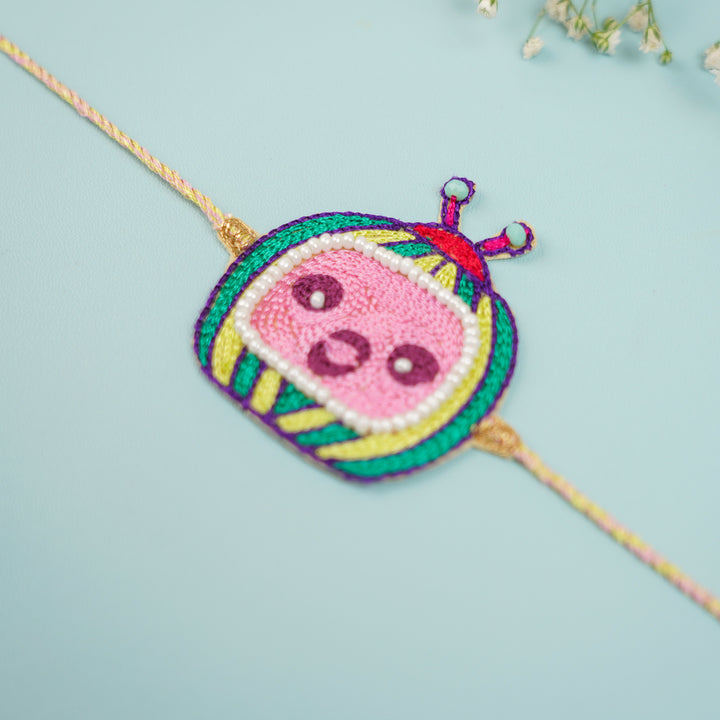 Handmade Beaded Cocomelon Theme Kids Rakhi With Roli Chawal - Close-up Angled View