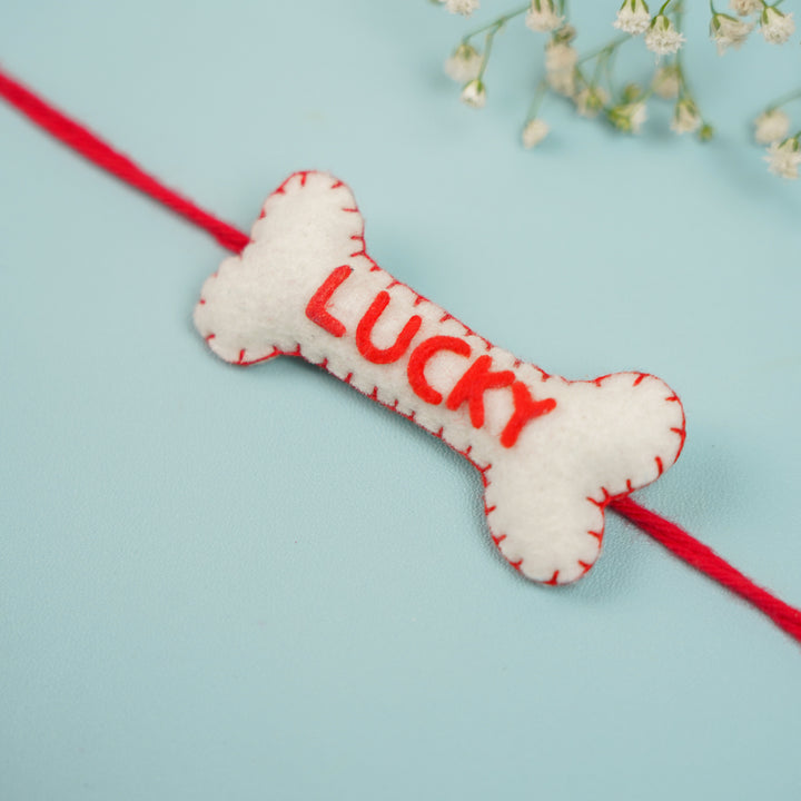 Personalized Handmade Bone Theme Felt Rakhi With Roli Chawal - Close-up of Lucky bone charm