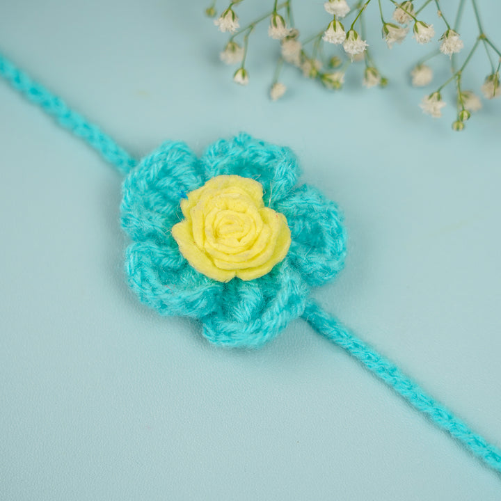 Handmade Crochet Blush Bloom Rakhi With Roli Chawal - Close-up of Blue Yellow Flower Rakhi
