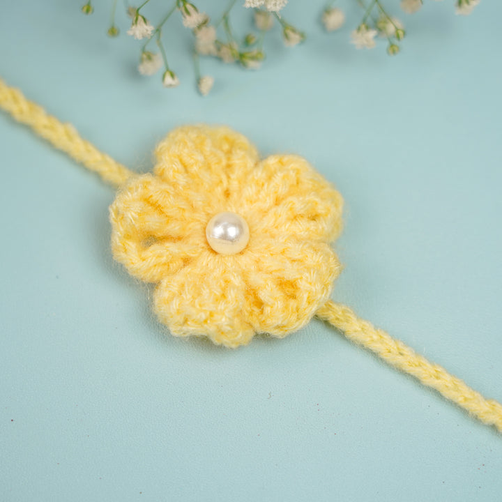Customized Handmade Crochet Floral Rakhi With Roli Chawal For Brother - Side View of Yellow Rakhi with Accessories