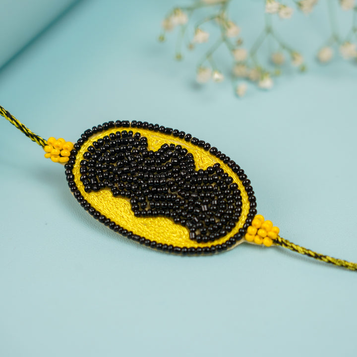 Handmade Beaded Batman Theme Rakhi With Roli Chawal For Brother - Close-up of Beaded Rakhi