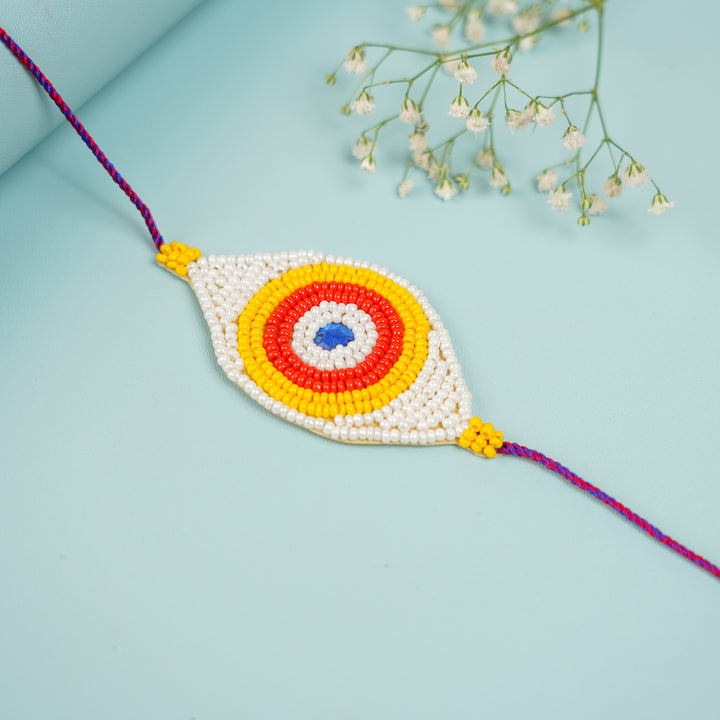 Handmade Beaded Colourful Evil Eye Rakhi With Roli Chawal - Close-up View of Beaded Rakhi