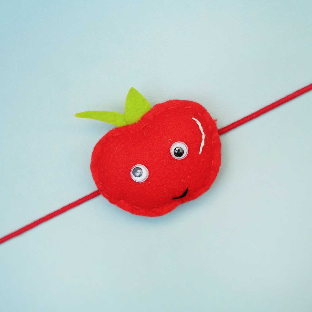 Handmade Apple Felt Rakhi With Roli Chawal - Close-up of single rakhi charm