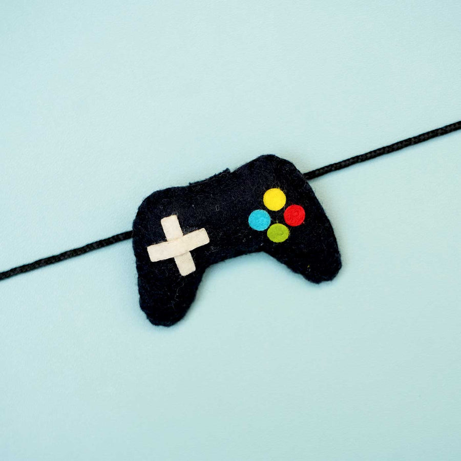 Handmade Controller Felt Rakhi With Roli Chawal - Close-up of Game Controller Bracelet