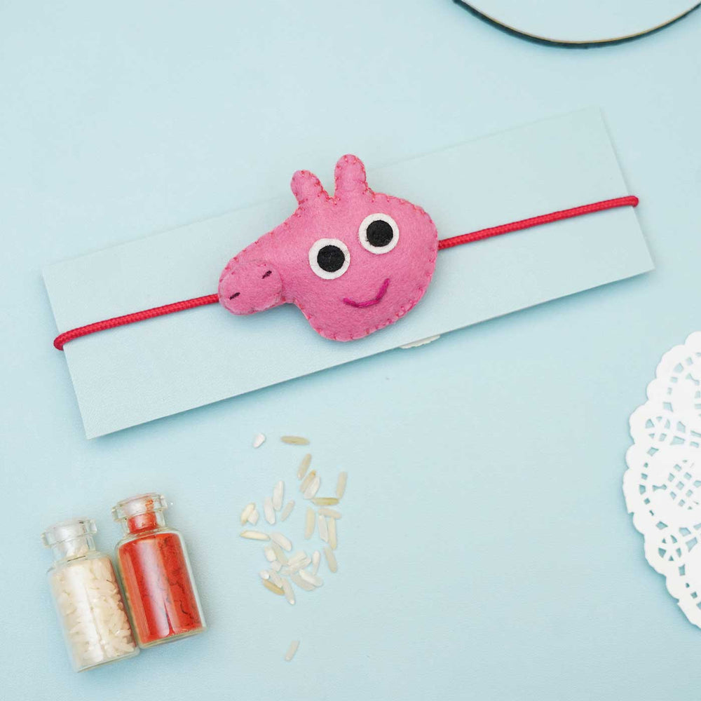 Handmade Peppa Pig Felt Rakhi With Roli Chawal - Flat Lay with Pink Rakhi on Card