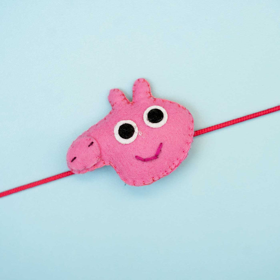 Handmade Peppa Pig Felt Rakhi With Roli Chawal - Close-up on Single Pink Rakhi