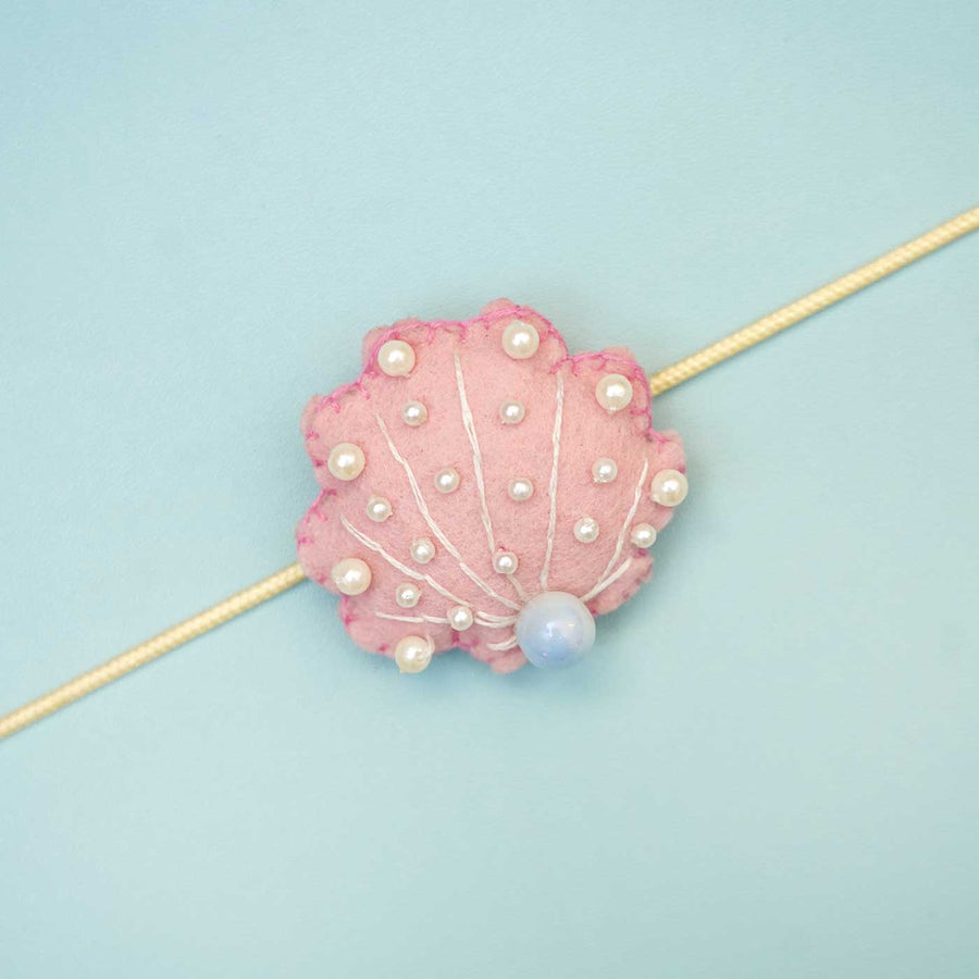 Handmade Seashell Felt Rakhi With Roli Chawal - Close-up of Single Pink Bracelet