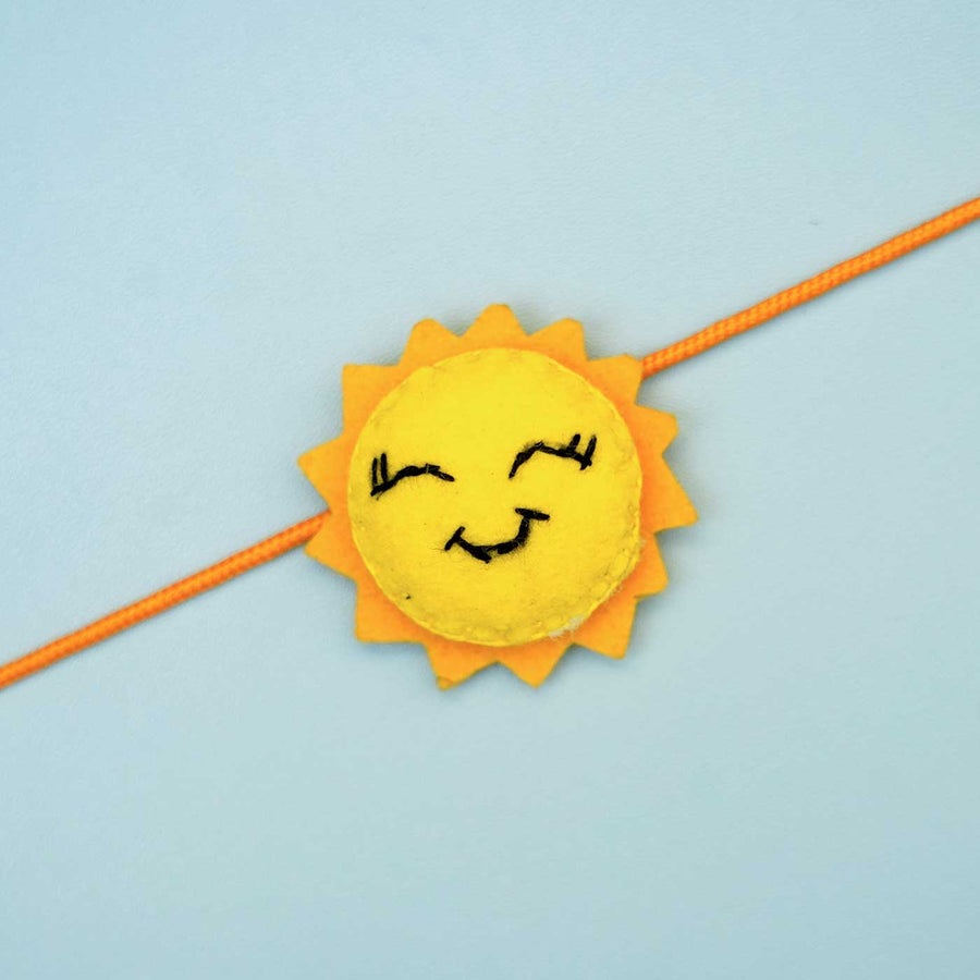 Handmade Sun Felt Rakhi With Roli Chawal - Close-up of Sun Rakhi