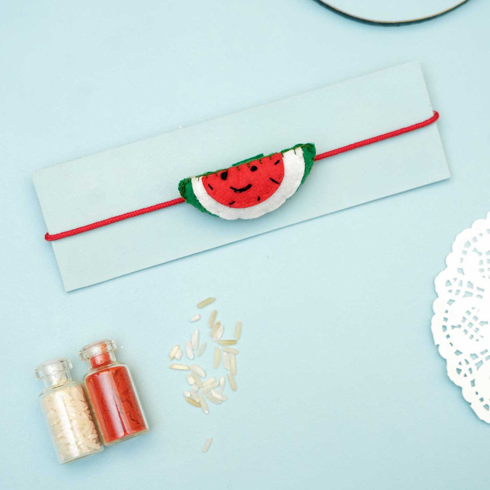 Handmade Watermelon Felt Rakhi With Roli Chawal - Watermelon Rakhi on Cardboard