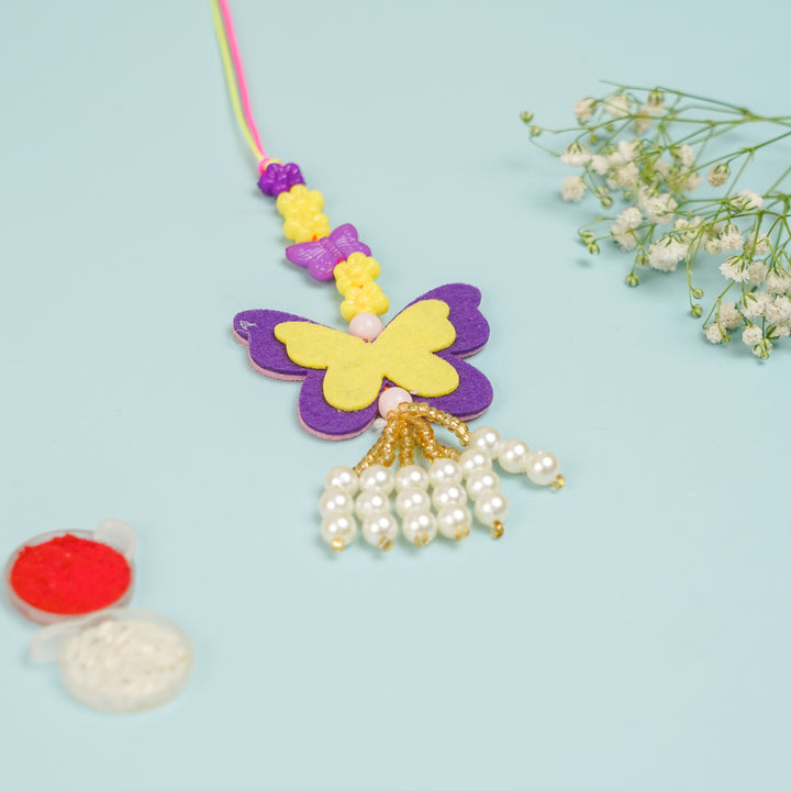 Handmade Buttefly Theme Felt Kids Lumba Rakhi For Girls With Roli Chawal - Top View with Accessories