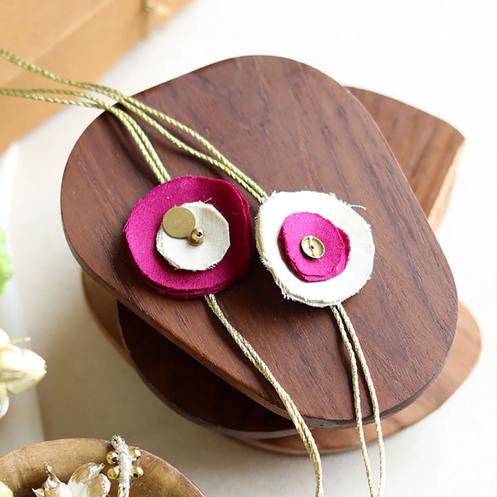 Handmade Reusable Floral And Gold Accent Upcycled Fabric Rakhi With Roli Chawal For Brother Set Of 2 - Close-up of fastener detail