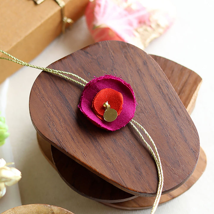 Handmade Reusable Floral And Gold Accent Upcycled Fabric Rakhi With Roli Chawal For Brother - Single flower detail on wooden spool (5)