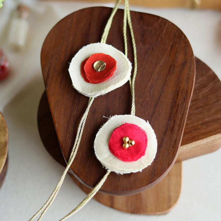 Handmade Reusable Dual Layer Upcycled Fabric Rakhi With Roli Chawal For Brother Set Of 2 - Close-up Detail of Necklace Flowers