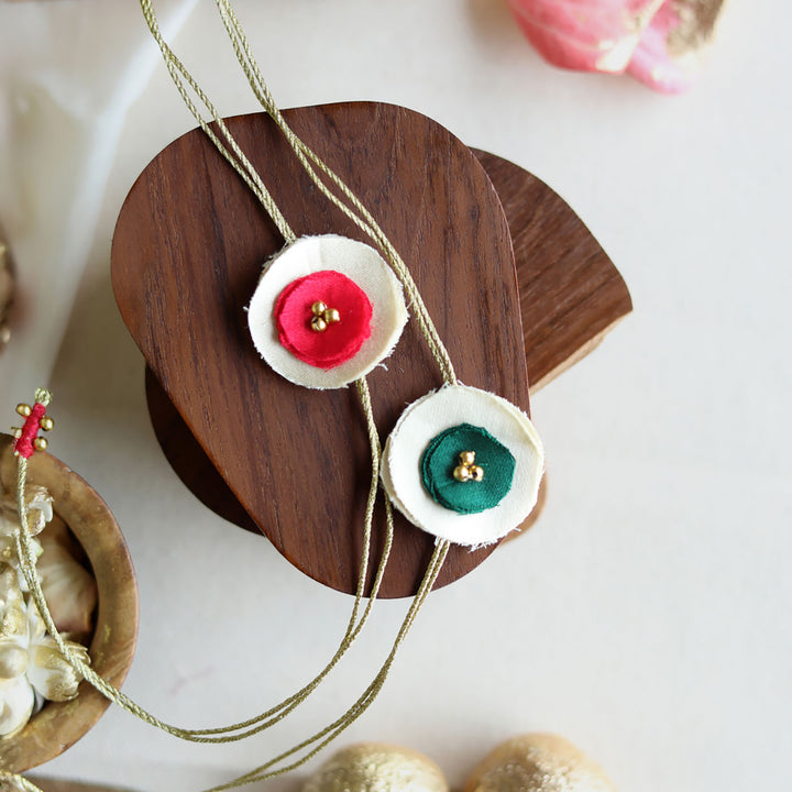 Handmade Reusable Dual Layer Upcycled Fabric Rakhi With Roli Chawal For Brother Set Of 2 - Close-up of Red and Green Flowers