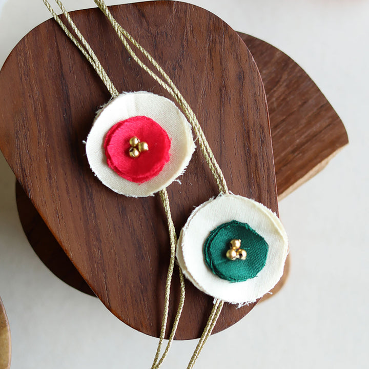 Handmade Reusable Dual Layer Upcycled Fabric Rakhi With Roli Chawal For Brother Set Of 2 - Close-up of Pink and Green Flowers