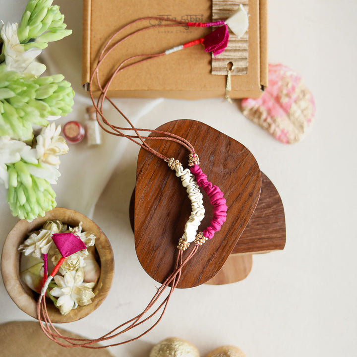 Handmade Reusable Beaded Ruched Upcycled Fabric Rakhi With Roli Chawal For Brother Set Of 2 - Top View with Surrounding Decor