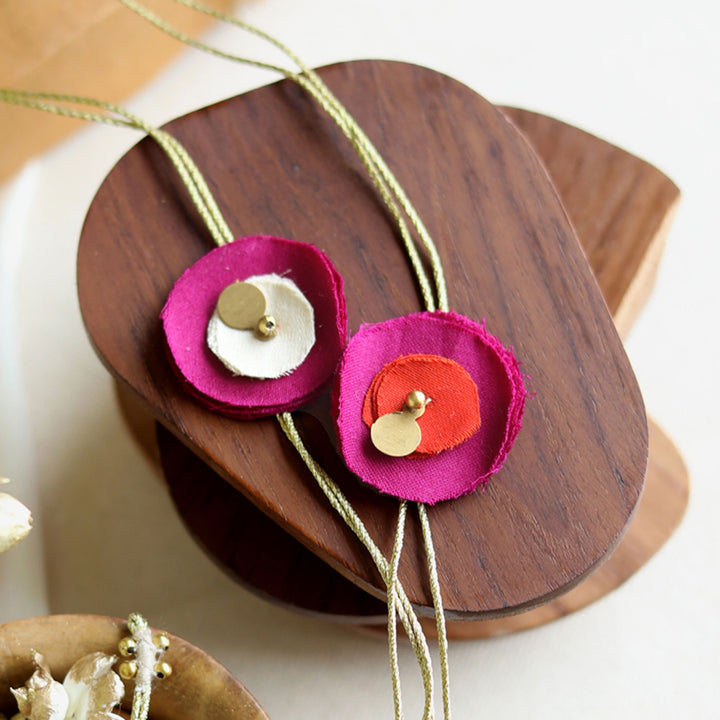 Handmade Reusable Floral And Gold Accent Upcycled Fabric Rakhi With Roli Chawal For Brother Set Of 2 - Close-up with alternate color fastener