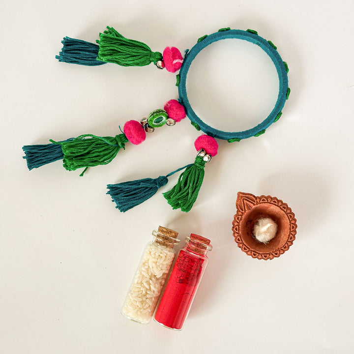 Handmade Beaded Blue Ghungroo And Mirror Cotton Bangle Lumba With Roli Chawal For Bhabhi - Top View with Complementary Items