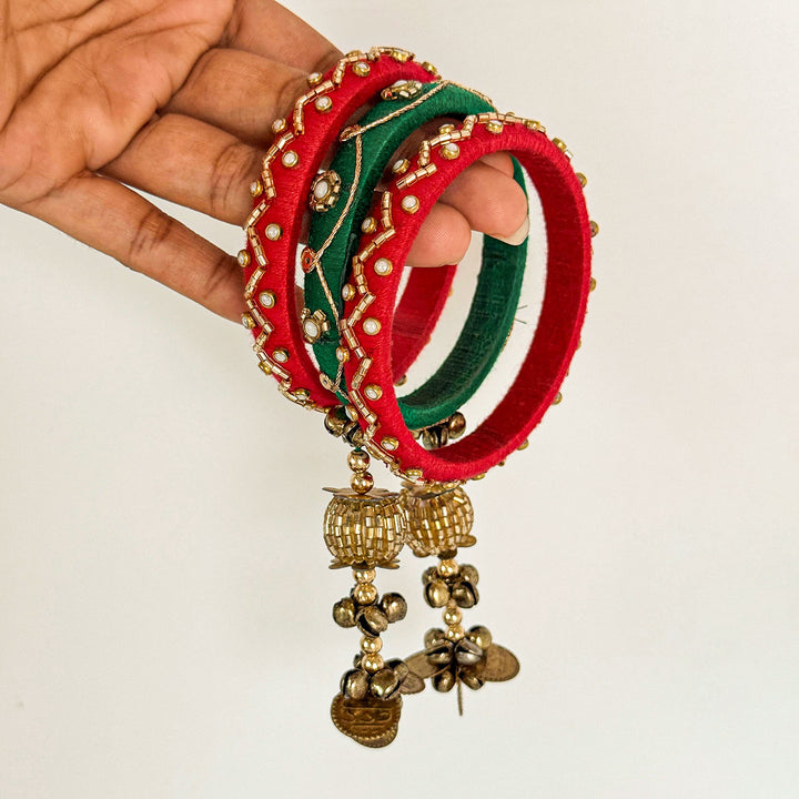 Handmade Beaded Red Green Ghungroo Cotton Bangle Lumba With Roli Chawal For Bhabhi - Held in Hand Close-up