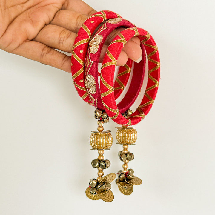 Handmade Beaded Pink Traditional Ghungroo And Zari Cotton Bangle Lumba With Roli Chawal For Bhabhi - Hand Holding Bangles Close-up