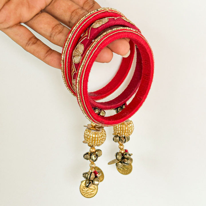 Handmade Beaded Traditional Ghungroo Cotton Bangle Lumba With Roli Chawal For Bhabhi 1 - Side View Held in Hand with Charms