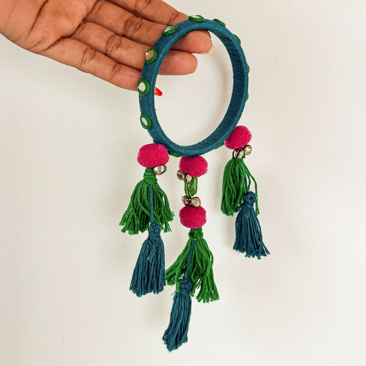 Handmade Beaded Blue Ghungroo And Mirror Cotton Bangle Lumba With Roli Chawal For Bhabhi - Held in Hand