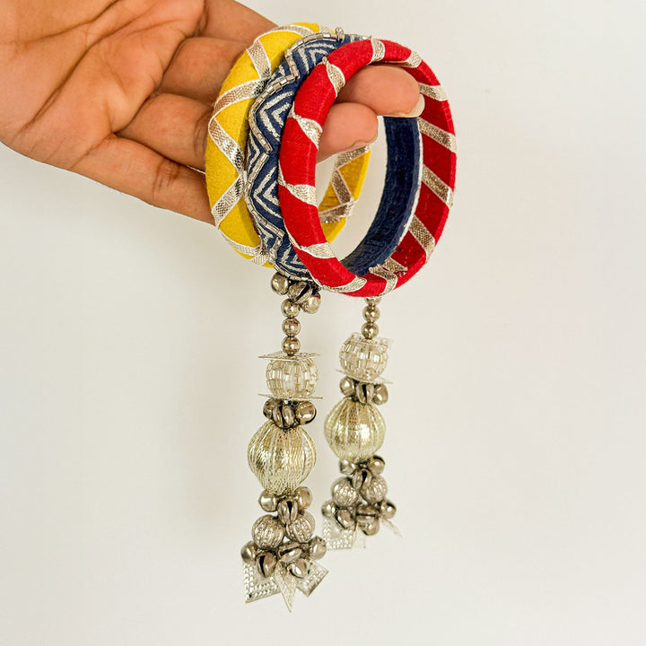 Handmade Beaded Traditional Ghungroo And Zari Cotton Bangle Lumba With Roli Chawal For Bhabhi - Hand Holding Bangles Close-up