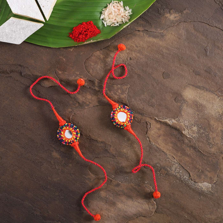 Handmade Mirror Work Rakhi With Roli Chawal Set Of 2 - Top View with Decorative Items