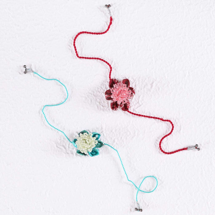 Handmade Beaded Floral Moti Rakhi With Roli Chawal Set Of 2 - Flat Lay on White Background