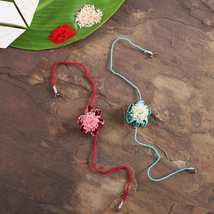 Handmade Beaded Floral Moti Rakhi With Roli Chawal Set Of 2 - Flat Lay with Accessories