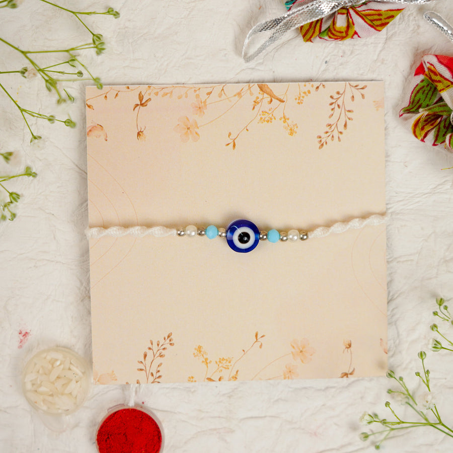 Handmade Evil Eye Rakhi With Roli Chawal - Front View on Decorative Card