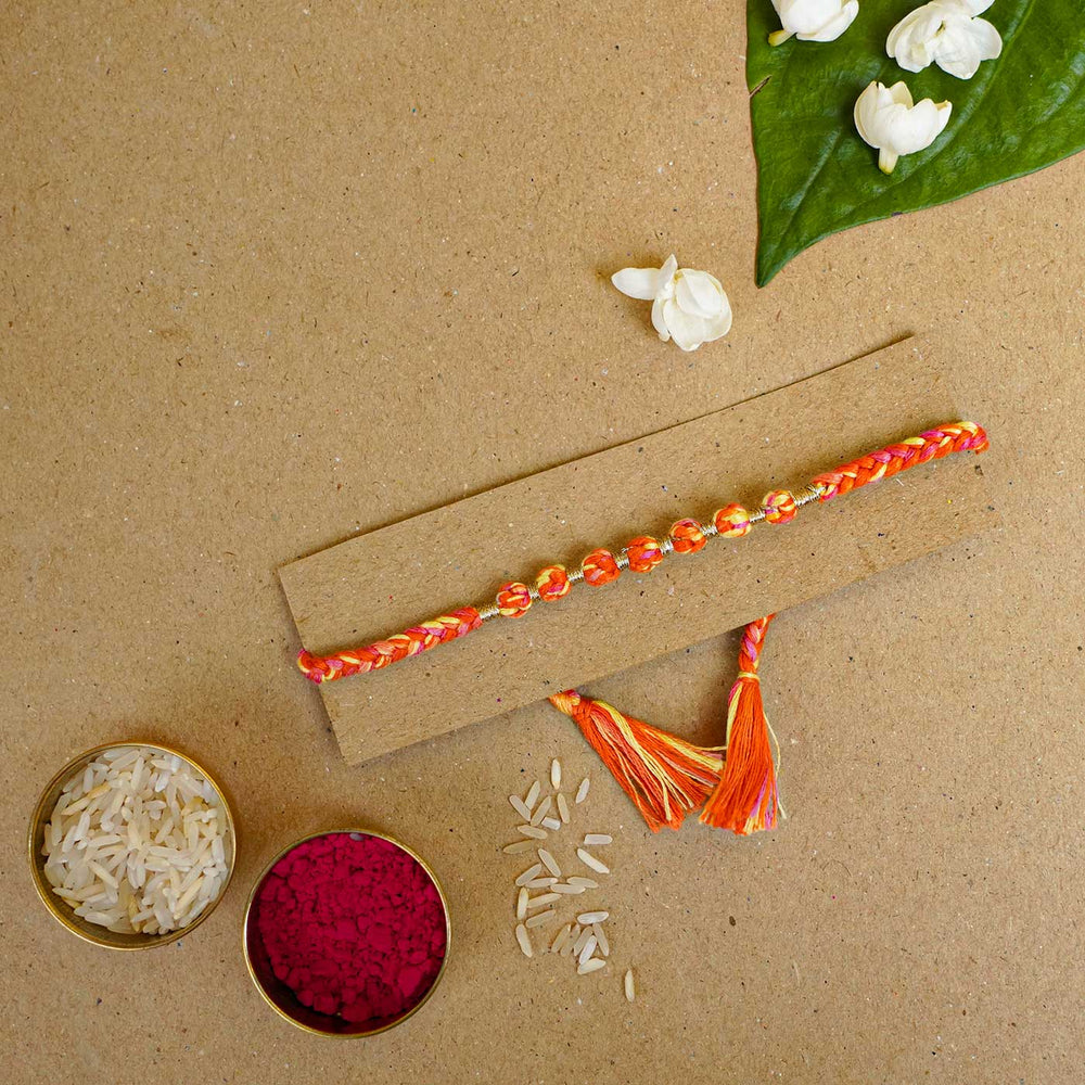 Reusable Beaded Orange Ombre Knot Rakhi With Roli Chawal - Styled Rakhi with festival items