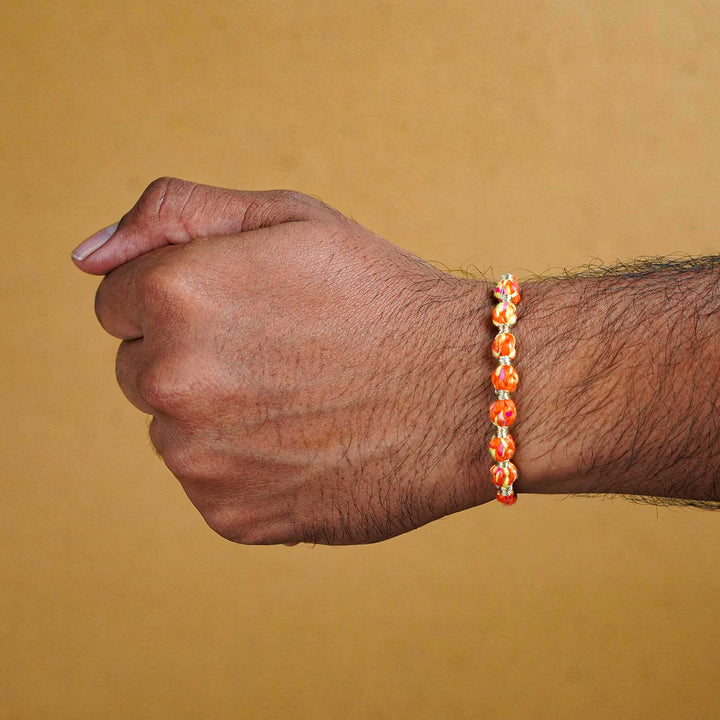 Reusable Beaded Orange Ombre Knot Rakhi With Roli Chawal - Worn Rakhi on wrist