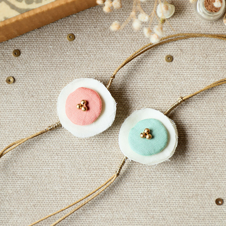 Handmade Reusable Layered Petal Beads Upcycled Fabric Rakhi With Roli Chawal For Brother Set Of 2 - Close-up of Two Bracelets