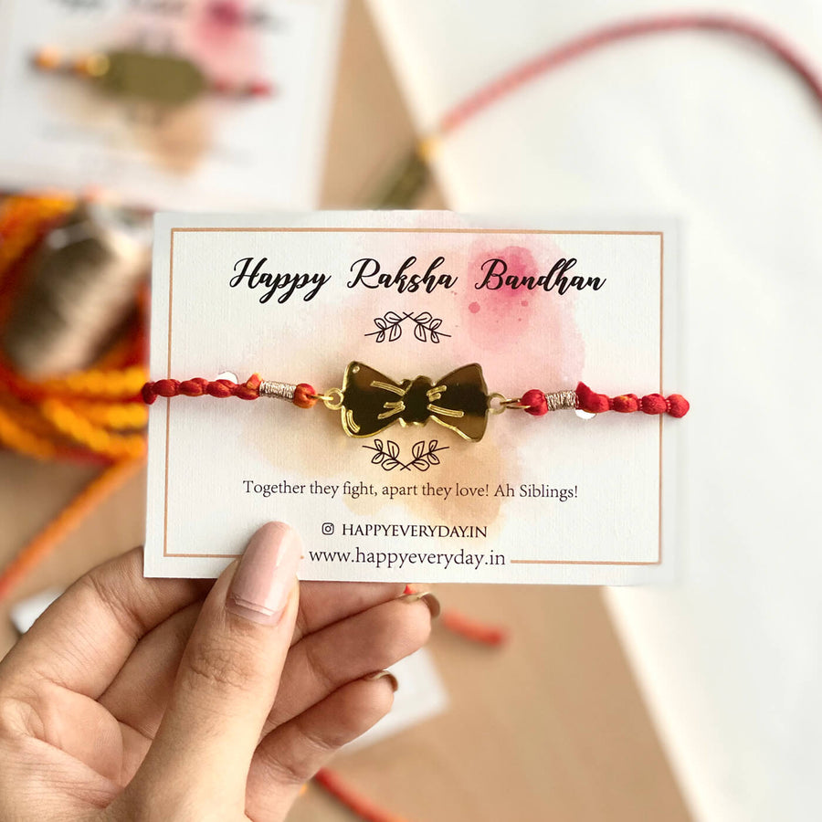 Handcrafted Golden Acrylic Rakhi With Roli Chawal 3 - Front View on Card
